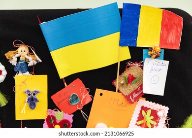 Ukrainian and Romanian flags side by side, with 1st of March trinkets, Eastern Europe symbol for first day of spring season.