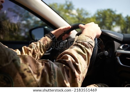 ukrainian soldier drive civilian car. Focused on road