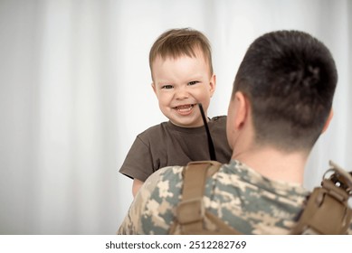 Ukrainian soldier in military uniform helps a child - Powered by Shutterstock