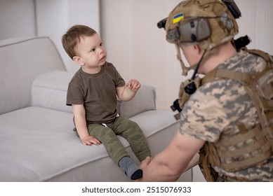 Ukrainian soldier in military uniform helps a child - Powered by Shutterstock