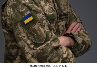 Ukrainian Soldier Wearing Military Uniform With Flag And Chevron Depicting Trident - Ukrainian Emblem And National Symbol