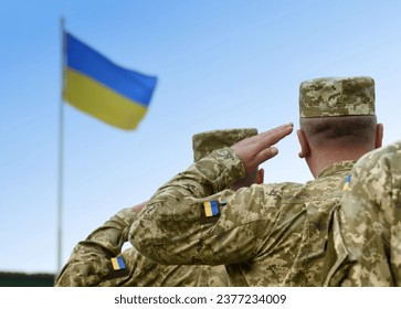 Ukrainian soldiers giving salute. Flag of Ukraine. Ukrainian military.  - Powered by Shutterstock