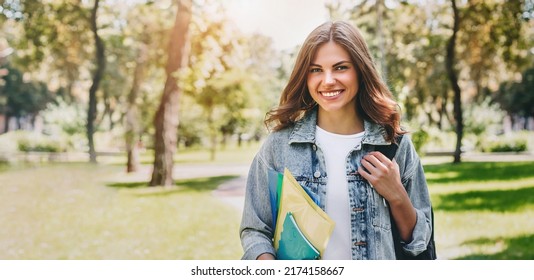 Ukrainian Student Girl Smiling And Walking In The Park. Cute Yong Woman Holding Folders And Notebooks In Hands. Social Training Program. Learn English. Web Banner. Copy Space