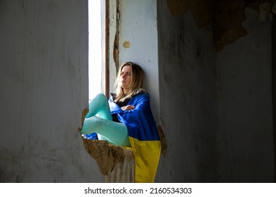 Ukrainian Woman In A Destroyed House. War In Ukraine. A Woman Prays For Peace. Girl Praying For An End To The War. Peace Concept. Consequences Of The War In Ukraine. Destroyed Ukrainian Houses