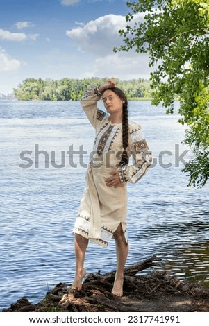 Ukrainian woman in an embroidered shirt or vyshyvanka near river Dnipro.