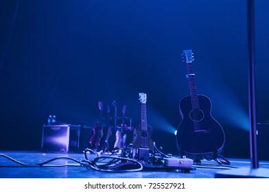 Ukulele And Acoustic Guitar On An Empty Stage  