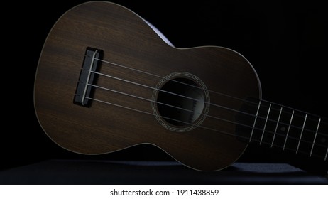 Ukulele sideways on black table with red tones - Powered by Shutterstock