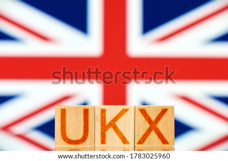 ukx index concept. wooden blocks with ukx lettering on british flag background
