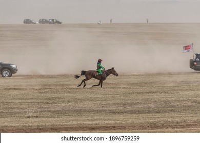 Ulaanbaatar City, Ulaanbaatar, Mongolia - 07 12 15: Mongolian Child Jockey On A Galloping Horse Leading A Naadam Festival Horse Race In Mongolia