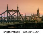 Ulm, Baden-Wuerttemberg/Germany: The old and steel bridge "Neutor" at sunset with a red sky. The church tower of the ulmer minster is visible in the background.