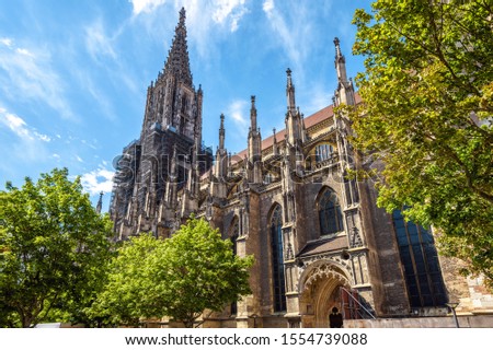 Ulm Minster, Cathedral of Ulm city, Germany. Ulmer or Munster on German is famous landmark of Ulm. Panorama of ornate facade of Gothic church in summer. Nice scenery of medieval European architecture