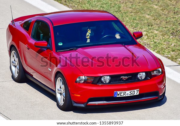 Ulm,Germany-March\
30,2019: FORD MUSTANG car on the route.The Ford Mustang is an\
American car manufactured by\
Ford.