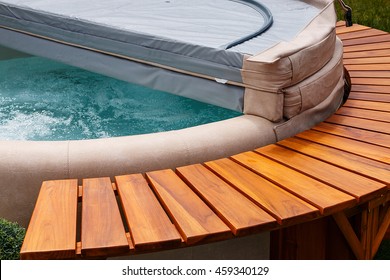 The Ultimate Garden Accessory A Free Standing Cedar Wood And Leather Circular Hot Tub With Cover.