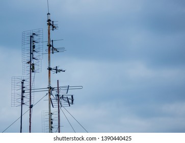 Ultra High Frequency TV Antena On Roof In Cloudy Day. 