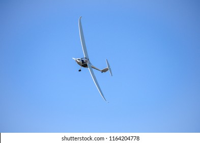 Ultra Light One Engine Monoplane Aircraft Flying In Blue Sky