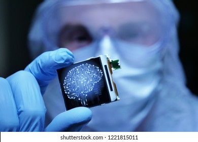in Ultra Modern Electronic Manufacturing Factory Design Engineer in Sterile Coverall Holds Microchip with symbols in futuristic holography. artificial intelligence, future of robots.