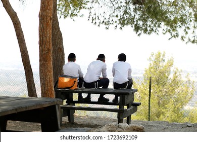 Ultra Orthodox Boys Sitting On A Table Watching The Landscape