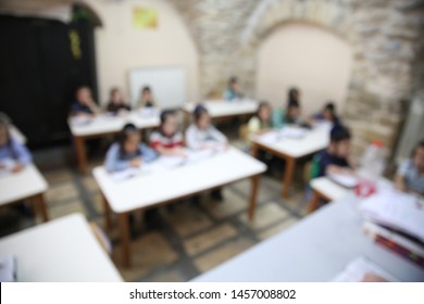 Ultra Orthodox Jewish Boys Sit At Their Desks And Listen To A Lecture Them, Blurred