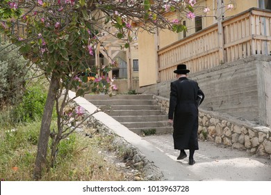 Ultra Orthodox Jewish Man Walks Up Stairs Between Homes And Buildings In Israel