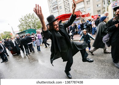 Ultra Orthodox Jewish men dance on the street in Uman. Jewish pilgrims arrive every year on Rosh Hashanah to pray at the grave of Rabbi Nachman of Breslov. Uman, Ukraine. September 2014
