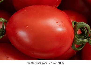 Ultra sharp macro of single ripe cherry tomato with water droplets, detailed fruit skin texture