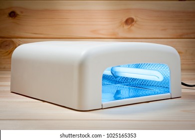 
Ultra Violet White Nail Lamp On A Wooden Background