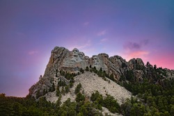 Ultra Wide Angle Landscape Image Of Mount Rushmore Against A Dusk Sky Of Pink And Purple. 