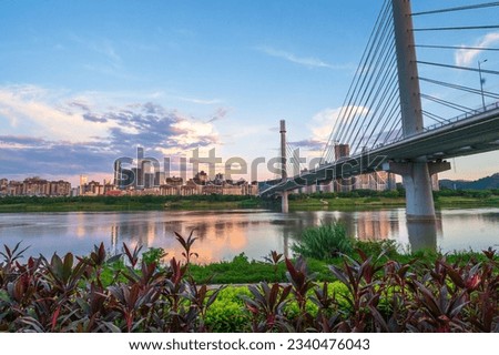 Ultra wide angle of a sunset over the skyline of Nanning , the capital city of Guangxi autonomous region in southern China at sunset by the city largest river