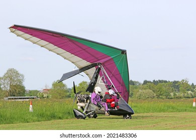 Ultralight airplane on a grass airfield	