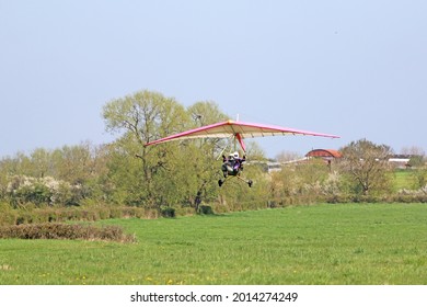 Ultralight airplane taking off from a grass strip	