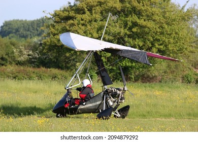 Ultralight flexwing airplane taxiing on a farm strip