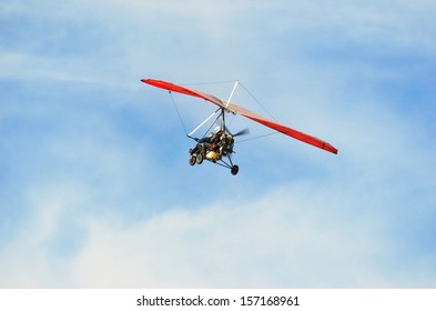 Ultralight trike flying with a pilot and a passenger