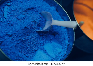 ultramarin blue pigment powder with white spoon in a pot  - Shutterstock ID 1372305242