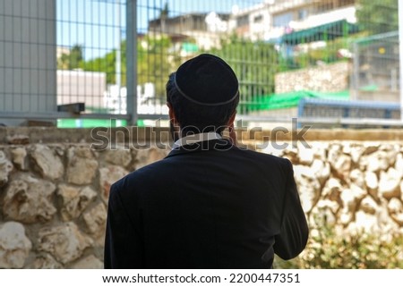 An ultra-Orthodox Jewish businessman talking on the phone
