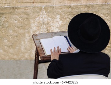 An Ultra-orthodox Jewish Man Prays At The Western Wall, The Holiest Site In Judaism