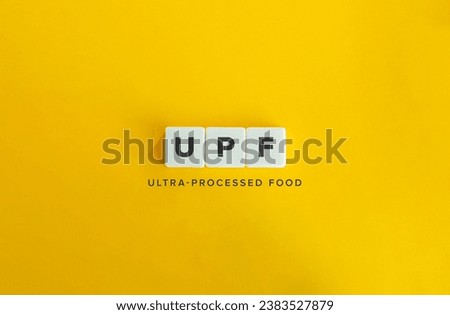 Ultra-processed food (UPF). Food Industry. Fast Food and Its Impact on Human Health. Letter Tiles on Yellow Background. Minimal Aesthetic.