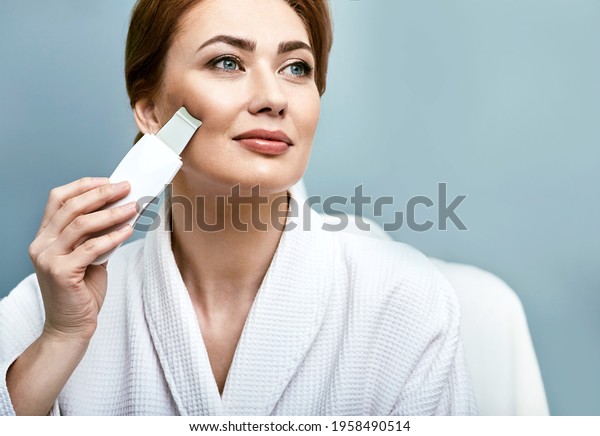 Ultrasonic facial peeling for a\
woman\'s face with ultrasonic scrubber. Cleansing facial\
skin