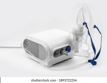 Ultrasonic Inhaler Or Nebulizer. Respiratory Medicine. Asthma Breathing Treatment With Oxygen Mask, Medical Equipment For Inhalation On White Background. High Quality Photo