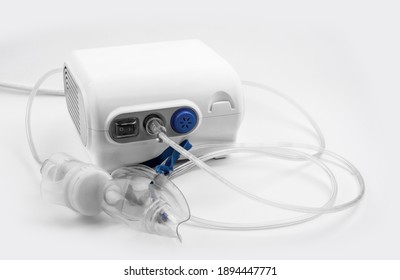 Ultrasonic Inhaler Or Nebulizer. Respiratory Medicine. Asthma Breathing Treatment With Oxygen Mask, Medical Equipment For Inhalation On White Background. High Quality Photo