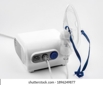 Ultrasonic Inhaler Or Nebulizer. Respiratory Medicine. Asthma Breathing Treatment With Oxygen Mask, Medical Equipment For Inhalation On White Background. High Quality Photo