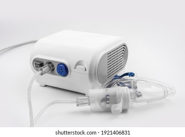 Ultrasonic Inhaler Or Nebulizer. Respiratory Medicine. Asthma Breathing Treatment With Oxygen Mask, Medical Equipment For Inhalation On White Background. High Quality Photo