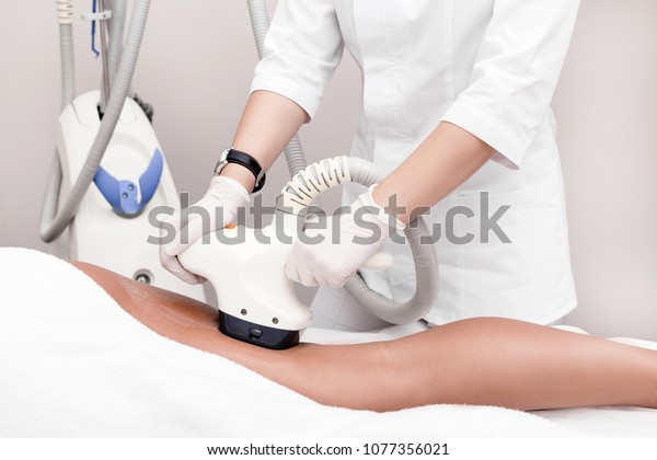 Ultrasound cavitation body contouring treatment.\
Woman getting anti-cellulite and anti-fat therapy on her leg in\
beauty salon.