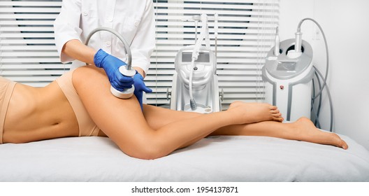 Ultrasound cavitation therapy. Beautiful woman having cavitation, procedure removing cellulite on legs and buttocks at a beauty clinic
