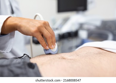 Ultrasound diagnosis of the stomach on the abdominal cavity of a man in the clinic, close-up view. The doctor runs an ultrasound sensor over the patient's male abdomen. Diagnostics of internal organs. - Powered by Shutterstock