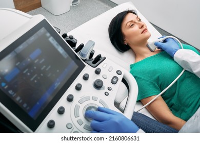 Ultrasound Diagnostics Of Endocrine System And Thyroid For Woman. Female Patient Receives Thyroid Diagnostics. Treatment Of Thyrotoxicosis And Hypothyroidism