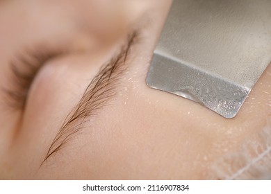 Ultrasound procedure in a cosmetology clinic. A woman undergoes a course of machine hardware cosmetic procedures. Beautiful face close up. - Shutterstock ID 2116907834