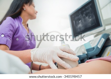 Ultrasound scanner in the hands of a doctor. Diagnostics. Sonography.