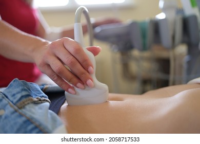 Ultrasound Scanner In Hands Of Doctor Examines Woman Pelvis