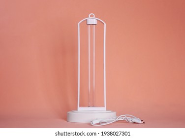 Ultraviolet Lamp On Peach Background. Air Sterilization