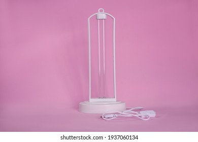 Ultraviolet Lamp On Pink Background. Air Sterilization